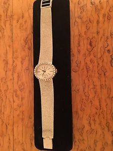 Baume and Mercier woman's watch 14K gold with bezeled diamonds