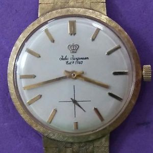 VINTAGE JULES JURGENSON WATCH WITH 14KT GOLD CASE, BEZEL, AND BAND WOUND, WORKS