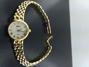 Lady's NEW 14k yellow gold Belair wristwatch, Swiss, sapp. crystal, MOP dial