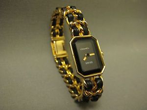 VINTAGE CHANEL BLACK FACE LADY'S WATCH WITH GOLD CHAIN AND BLACK LEATHER RIBBON
